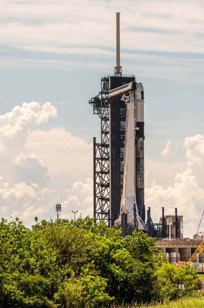 A view of Falcon 9 and Cargo Dragon Spacecraft at SpaceX's 39A launch site. The crew access arm is extended while preparations for launch are still ongoing.