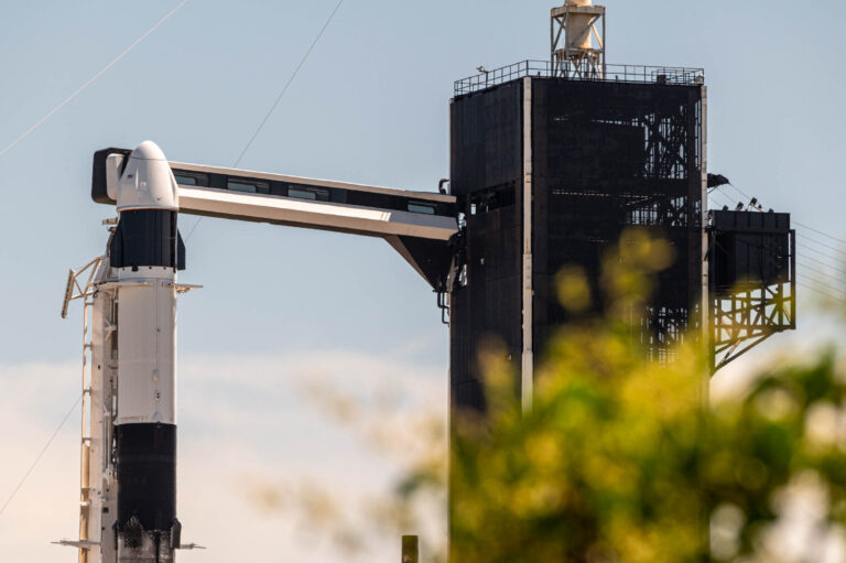 A view of Falcon 9 and Cargo Dragon Spacecraft at SpaceX's 39A launch site. The crew access arm is extended while preparations for launch are still ongoing.