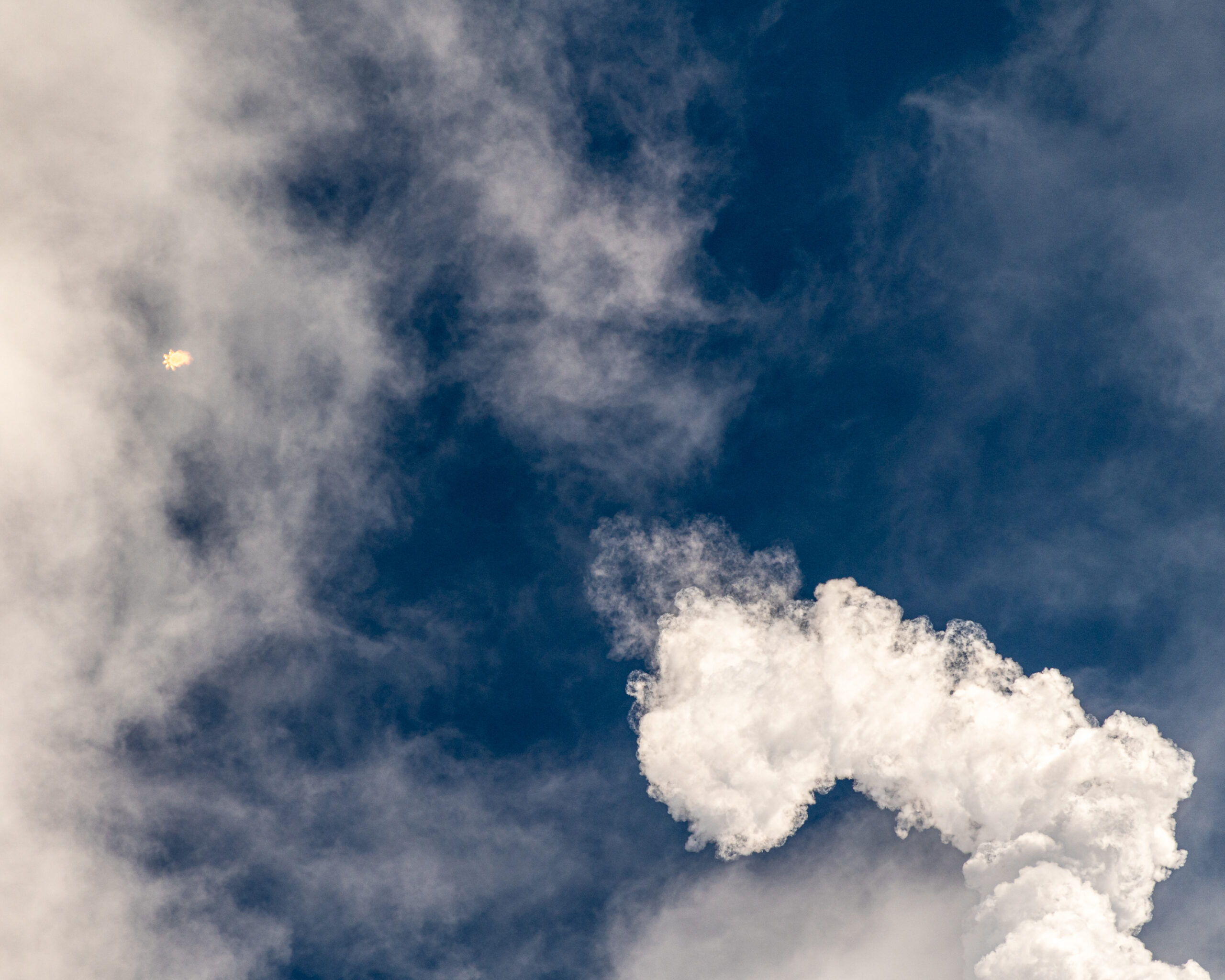 Clouds and the vapor plume left by Falcon 9 as Crew-5 is pitching downrange.