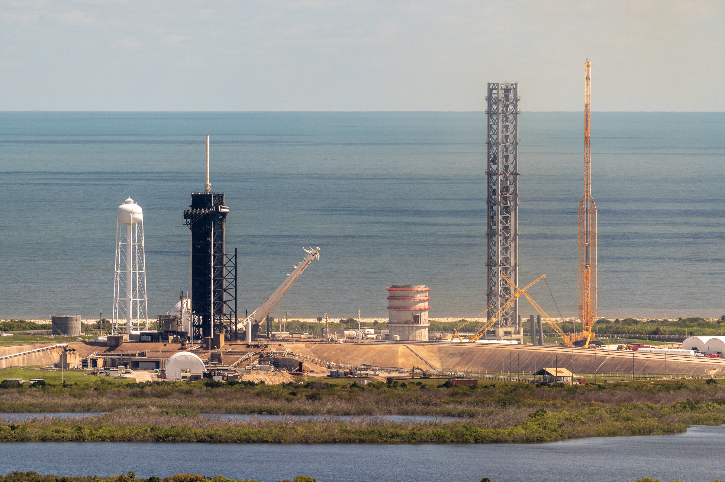 LC-39A after Crew-5 has launched. Strongback is halfway down from launch and the massive Starship tower and cranes for construction are in view.