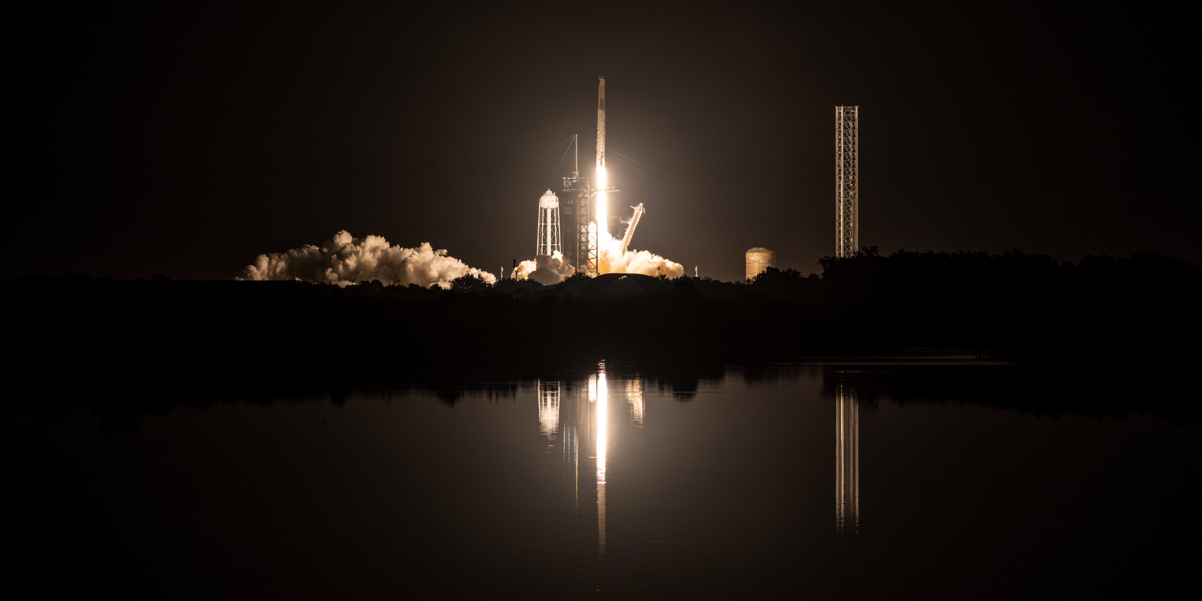 Falcon 9 lifting off with Crew Dragon Endurance. AS seen from the LC-39A Press Site lawn. Overlooking the Turn Basin at night.